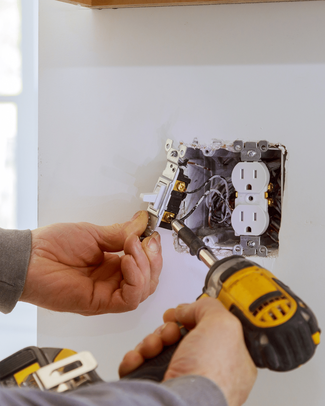 Licensed Fort Collins electrician from PH Electric installing a new electrical outlet safely and to code.
